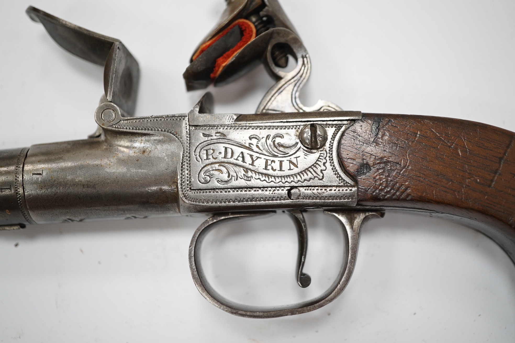 A cannon barrel flintlock boxlock travelling pistol by R. Daykin of Nottingham, with turn off cannon barrel, Tower private proof marks, signed frame upon foliate engraved background, slab walnut grip and sliding trigger